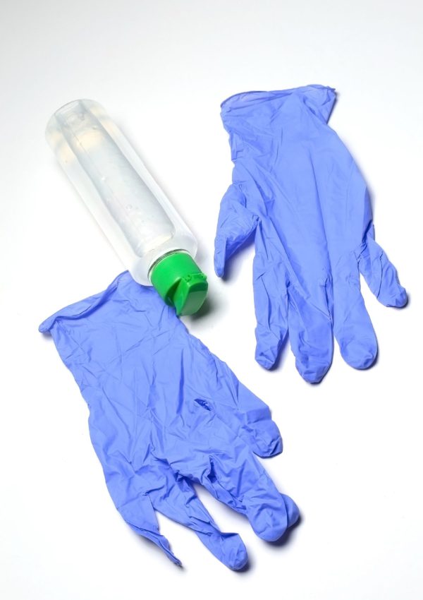 medical gloves and jar with sanitizer on a white background. close-up.